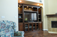 Stained Red Oak Custom Entertainment Center Cabinets with Barn Doors in Lantana Texas