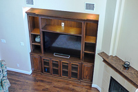 Stained Red Oak Custom Entertainment Center Cabinets with Barn Doors in Lantana Texas