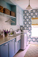 light blue custom laundry room cabinets with farm sink in Frisco Texas