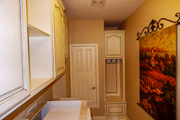 white with brown glaze custom laundry room cabinets in Denton Texas