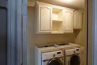 white with brown glaze custom laundry room cabinets in Denton Texas