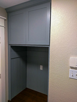 light blue custom mud room cabinet with stained bench seat in Denton Texas