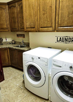 stained maple custom laundry room cabinets in Argyle Texas
